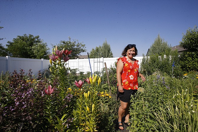 Amber Steele Poelstra stands among her locally grown blooms at her Post Falls home. The art teacher is the one-woman show behind Steelstra Designs, a custom floral arrangement business through which she shares the joy of homegrown, hand-cut flowers with the community.