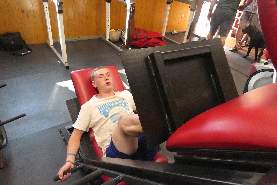 Noxon student Ian Brown works on leg strength on a machine in the Noxon High weight room this past week in preparation for the upcoming 6-player football season. (Chuck Bandel/VP-MI)