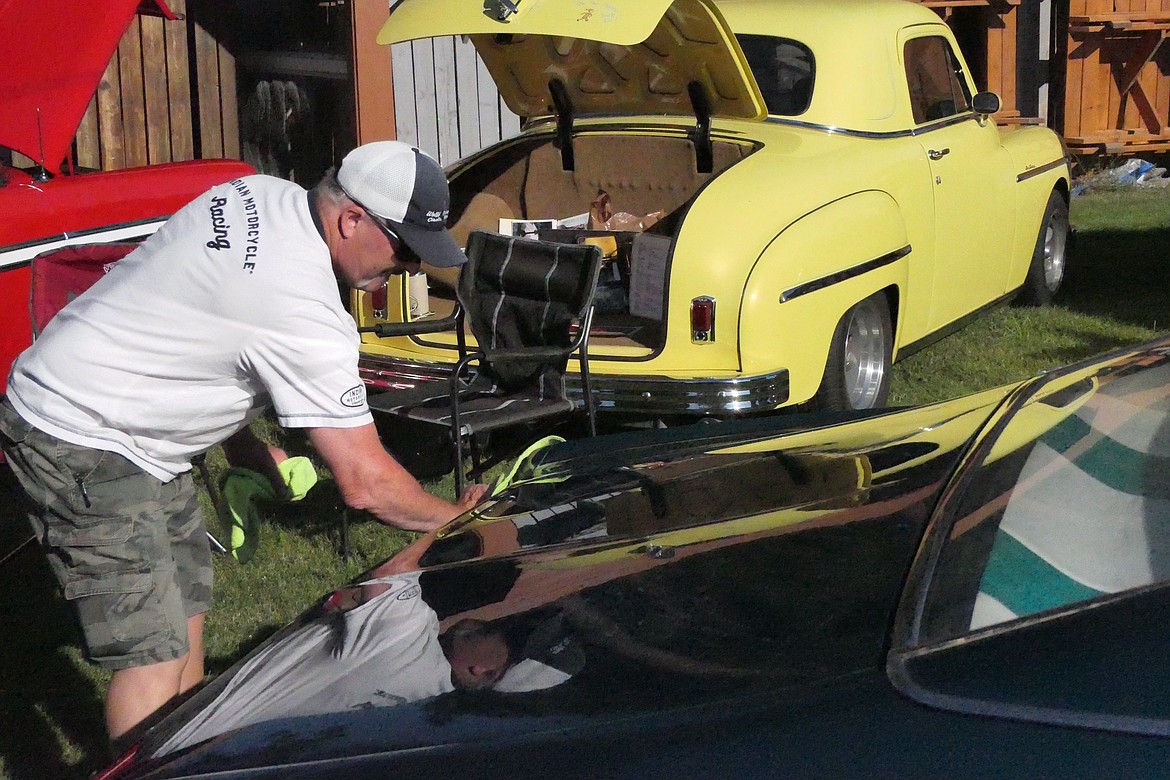 Thompson Falls resident Steve Perkins puts the finishing shine on his 1969 Chevy Impala prior to the start of this year's Cool Summer Nights Car Show in Trout Creek. (Chuck Bandel/VP-MI)