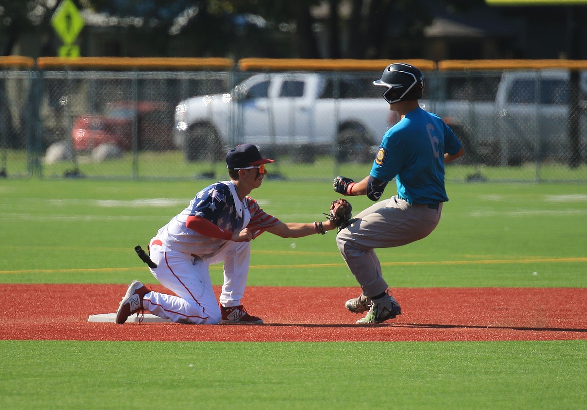 Shortstop Mason Little tags out Camas Prairie's J.T. Jackson during the first game on Saturday.