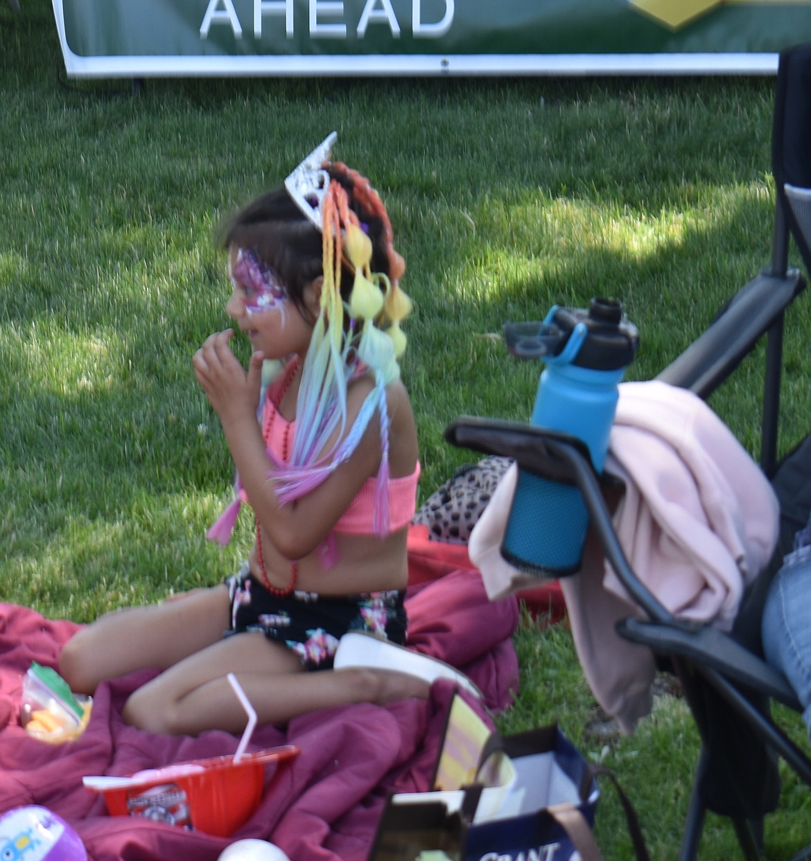 Myla Lopez, 6, of Soap Lake enjoys a snow cone at the Soap Lake Food and Folk Festival Saturday afternoon.