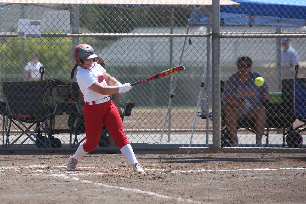 A batter for the 14U Washington Rage makes contact with a pitch for a single. The Rage were the lone local team in the tournament.