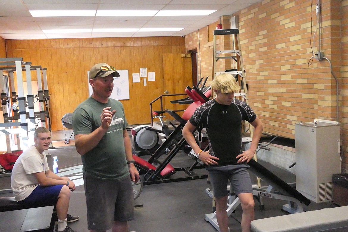 Noxon football coach Lucas MacArthur supervises voluntary weight lifting activities in the school's workout room last week.  (Chuck Bandel/VP-MI)