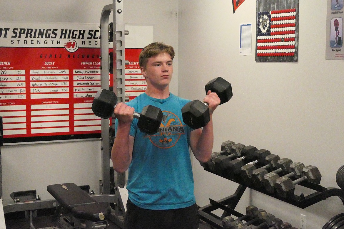 Hot Springs sophomore Andrew Waterbury works on arm strength with curls during a recent workout in the gym at Hot Springs High. (Chuck Bandel/VP-MI)