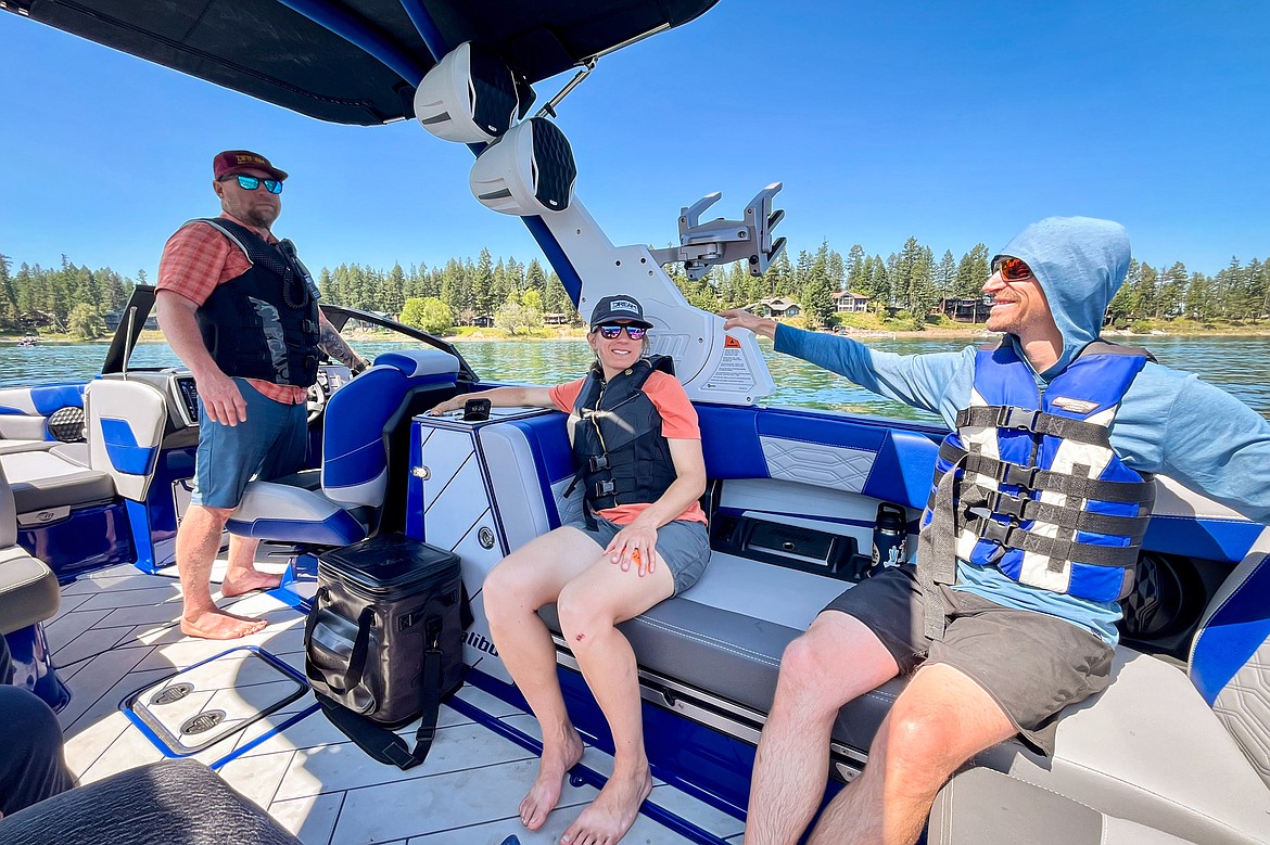 From left, Sean Lujan, co-founder of Backcountry Xperiences; Julie Tickle, executive director of DREAM Adaptive Recreation; and Trevor HIldebrand, staff at DREAM Adaptive, during DREAM Adaptive Recreation's Echo Lake Watersports Days on Tuesday, July 16. (Casey Kreider/Daily Inter Lake)