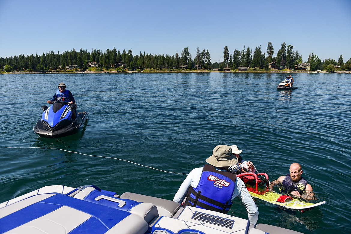 Volunteers and staff communicate to get Erik Barnes back on his adaptive water ski for another ride around Echo Lake during DREAM Adaptive Recreation's Echo Lake Watersports Days on Tuesday, July 16. (Casey Kreider/Daily Inter Lake)