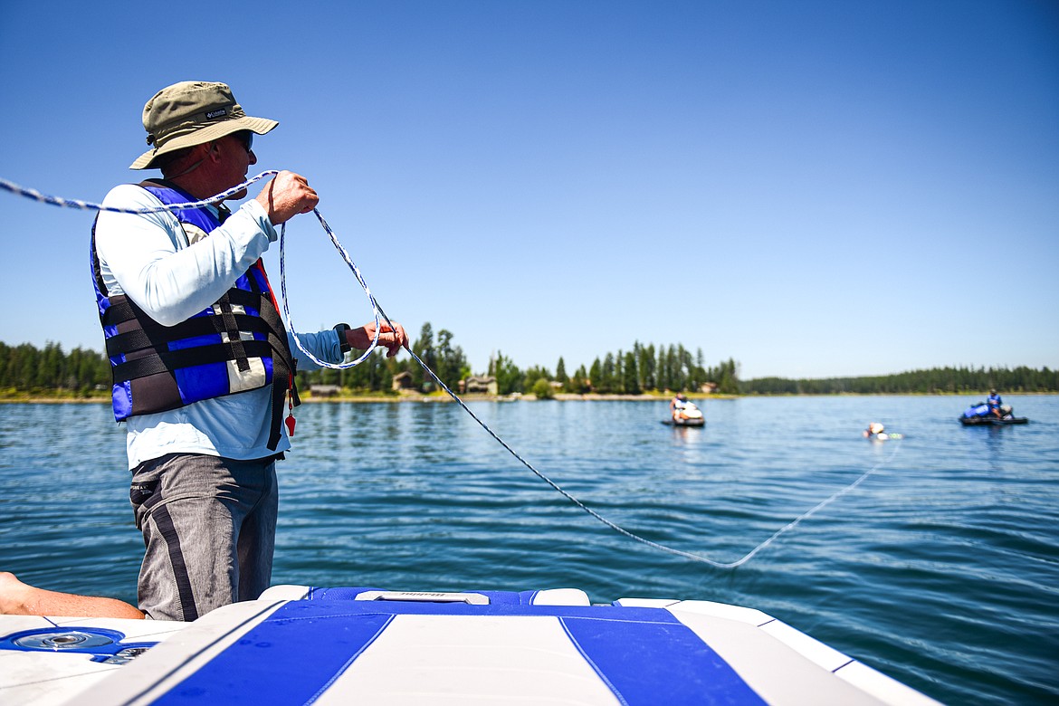 Volunteer Tom Mettler communicates with staff and volunteers to get Erik Barnes back on his adaptive water ski for another ride around Echo Lake during DREAM Adaptive Recreation's Echo Lake Watersports Days on Tuesday, July 16. (Casey Kreider/Daily Inter Lake)