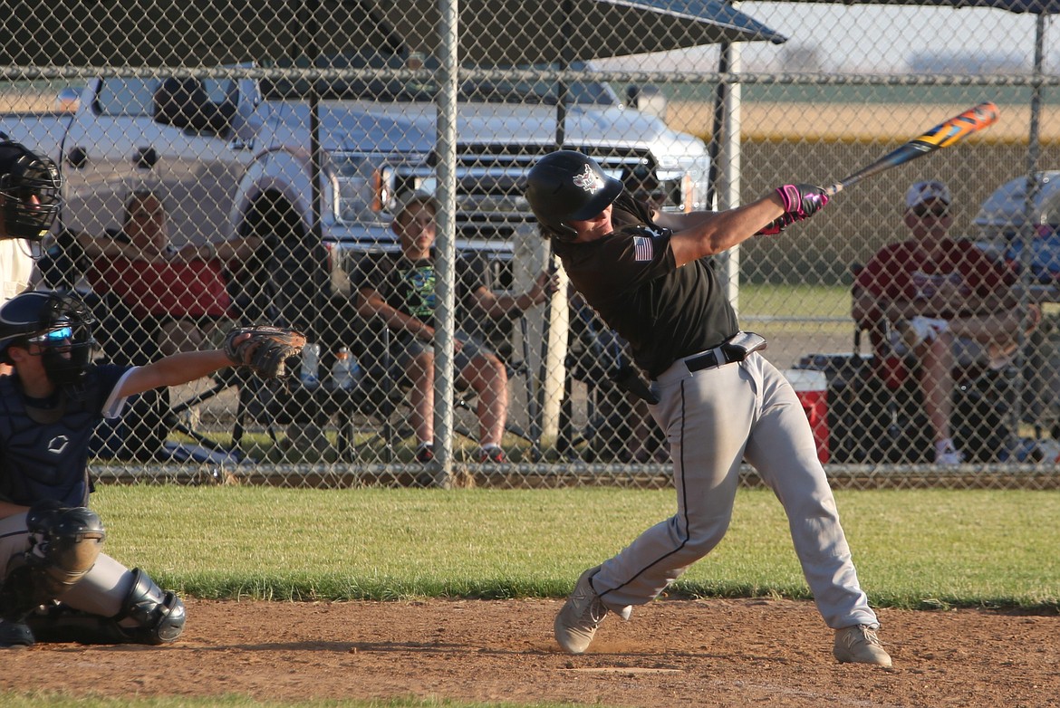 Almira/Coulee-Hartline Legion first baseman Grayson Beal, right, swings at a pitch during a game against Gonzaga Prep on Friday. Beal recorded three RBI in the nightcap of Saturday’s doubleheader against Ferris.