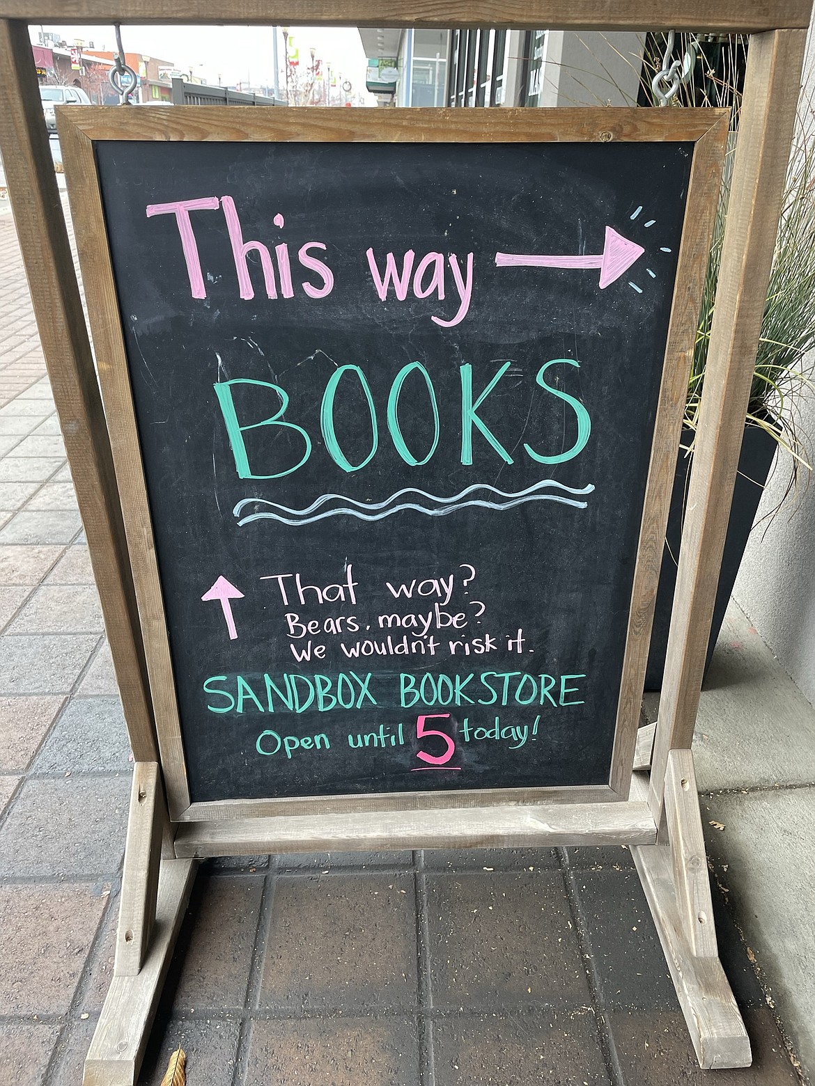 A sign outside the Smith-Martin Building points to the Sandbox Bookstore. The space, which once housed a single store, is now home to 14 businesses, with more space available.