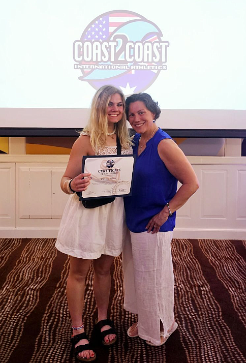 Mari Nelson and her mom, Deb Nelson, smile for the camera Sunday during the banquet following the Coast 2 Coast International Athletics three-day track meet in Australia. Mari fared well despite past knee surgeries and an abrupt illness ahead of the competition.