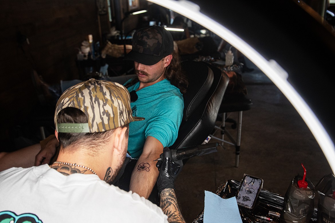 A festival-goer gets a flash tattoo at Under the Big Sky Friday, July 12. (Avery Howe/Bigfork Eagle)