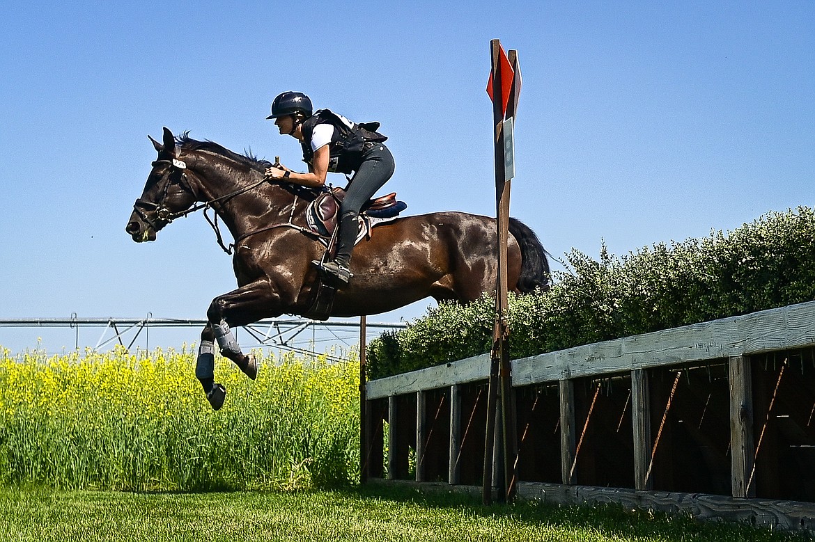 A rider clears a jump as she practices steeplechase along the course prior to The Event at Rebecca Farm on Wednesday, July 17. (Casey Kreider/Daily Inter Lake)