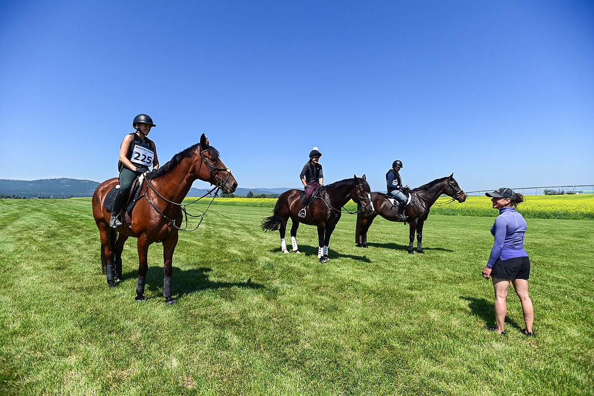 Rider Dani Sussman, right, speaks with a few of her clients who were practicing steeplechase on the course prior to The Event at Rebecca Farm on Wednesday, July 17. (Casey Kreider/Daily Inter Lake)