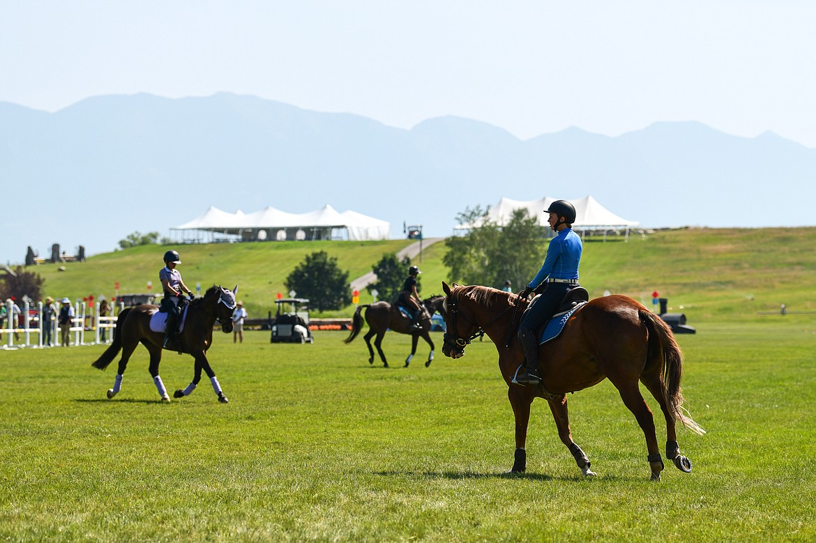 Riders lead their horses over practice jumps before The Event at Rebecca Farm on Wednesday, July 17. (Casey Kreider/Daily Inter Lake)