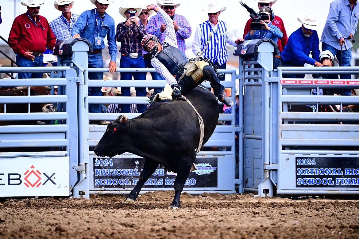 TAHJ WELLS of Browning rides his bull to a score of 82 Tuesday morning at Performance 4 at the National High School Rodeo Finals in Rock Springs, Wyo. Wells won that round and ended up second through the first go-round. (Jennings Rodeo Photography)