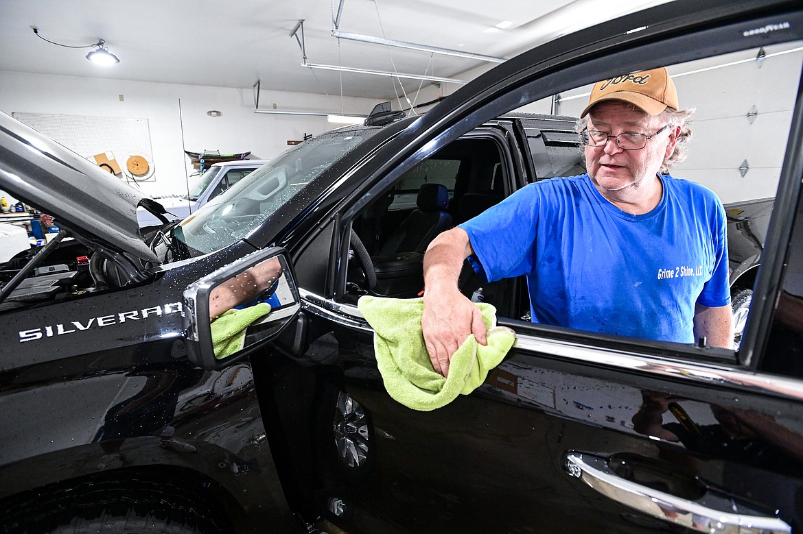 Keith McAtee, owner of Grime 2 Shine, details a customer's truck on Wednesday, July 17.