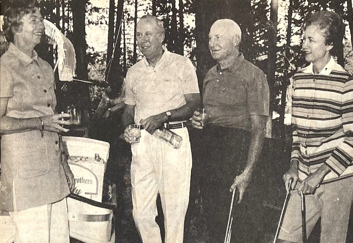 Hall of famer Ray Flaherty and his wife, Jacqueline, on the right, hobnob with friends during a round of golf at the Avondale Golf Course.