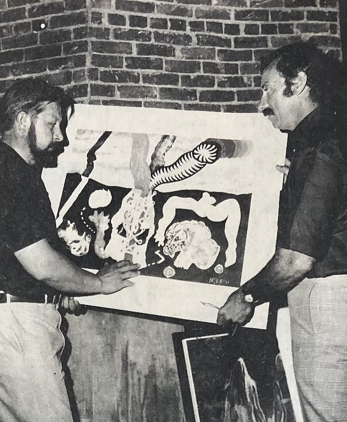 Rudy Autio of Missoula, left, and Pat Flammia judge paintings for 1969 Coeur d’Alene Outdoor Arts & Crafts Festival.