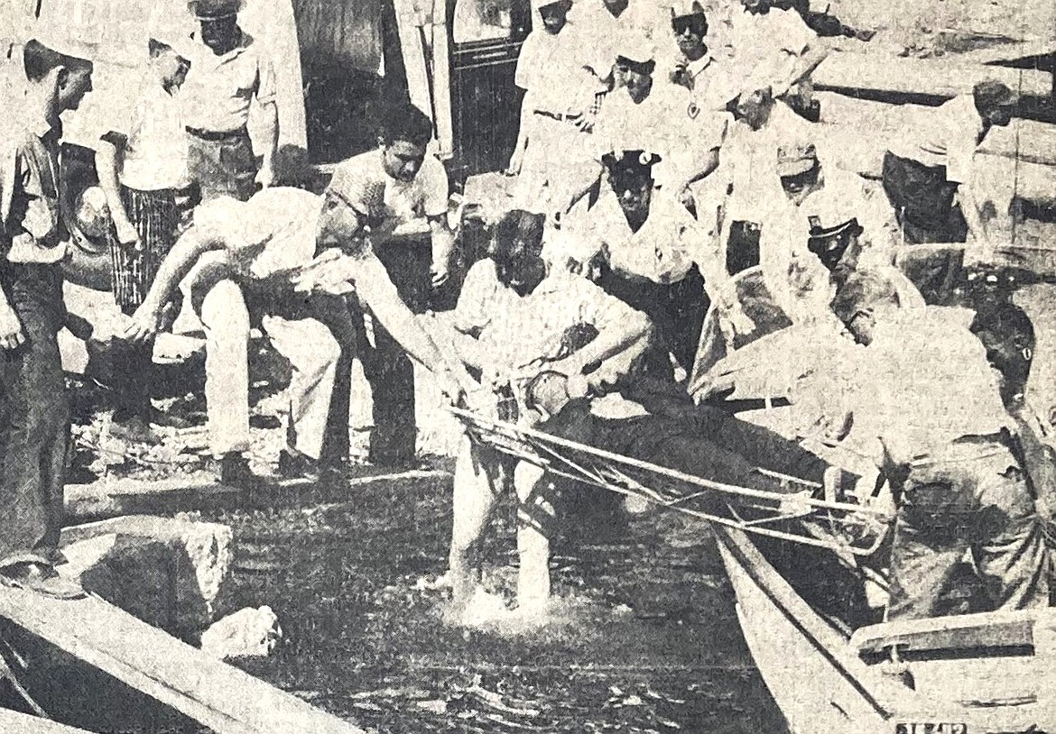 Jack Regas, driver of Miss Bardahl, is taken from the water unconscious after a boat crash during the1959 Diamond Cup hydroplane races.