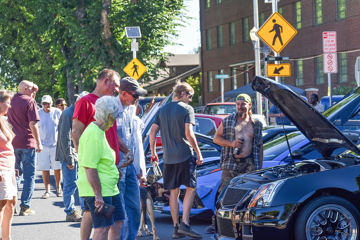 Attendees check out vehicles at last year’s Anything with Wheels Show and Shine car show. This year’s show is Saturday.