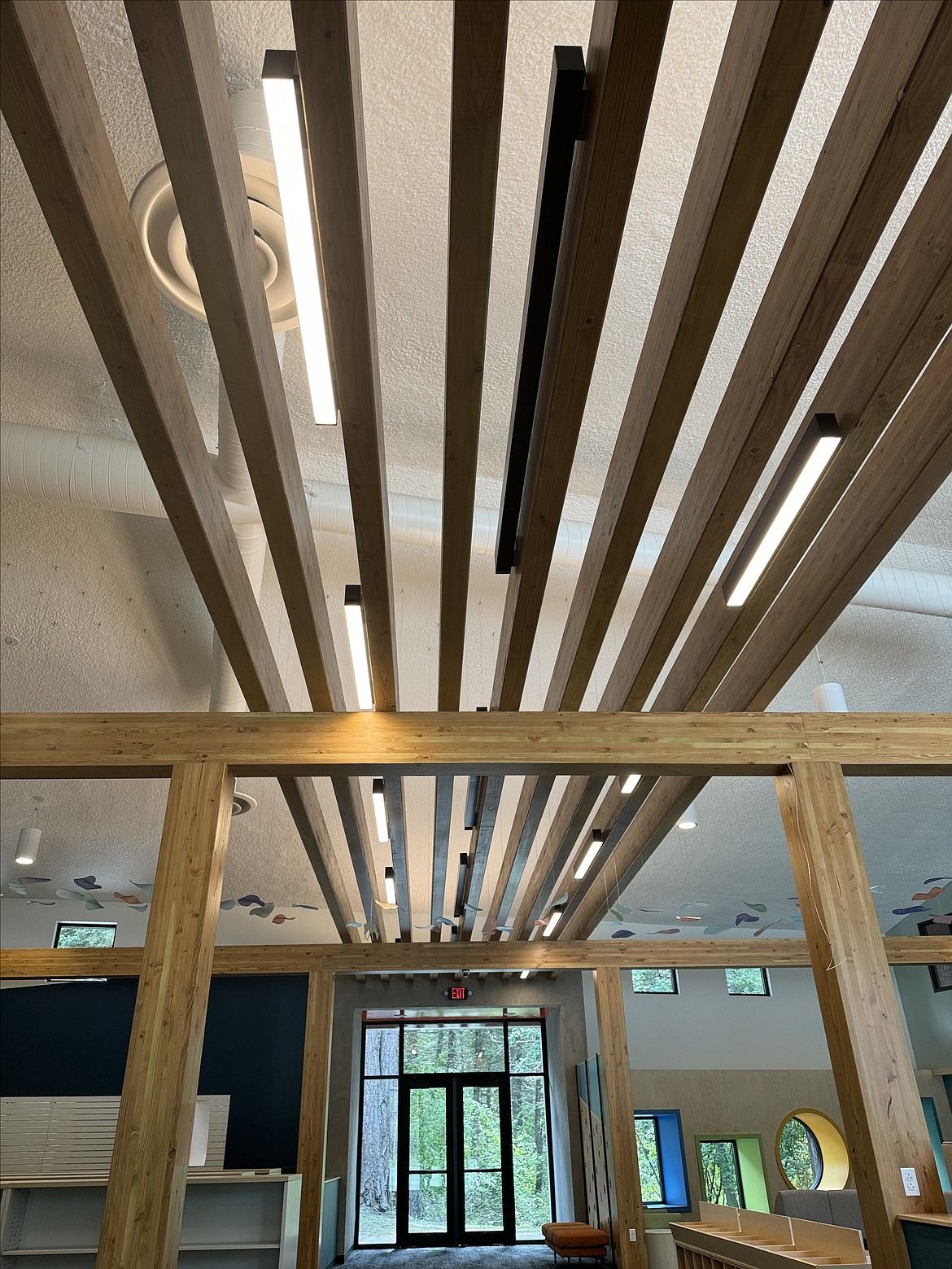 Beams run overhead at the new Bigfork branch of Flathead County Library, which Cushing-Terrell Interior Designer Jessica Murray said also harkens back to a theme surrounding bridges in the building design. (photo provided)