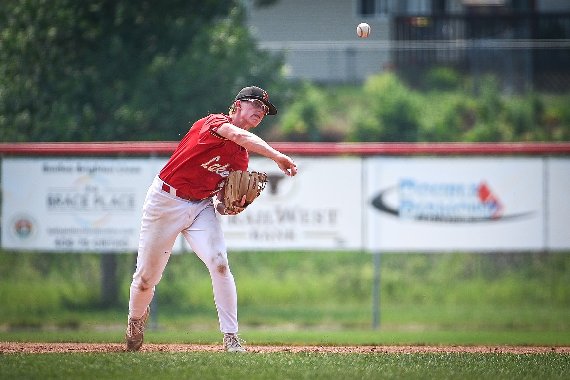 Lakers AA third baseman Luke Nikunen (12) throws to first after fielding a grounder against the Billings Scarlets at Griffin Field on Thursday, July 18. (Casey Kreider/Daily Inter Lake)