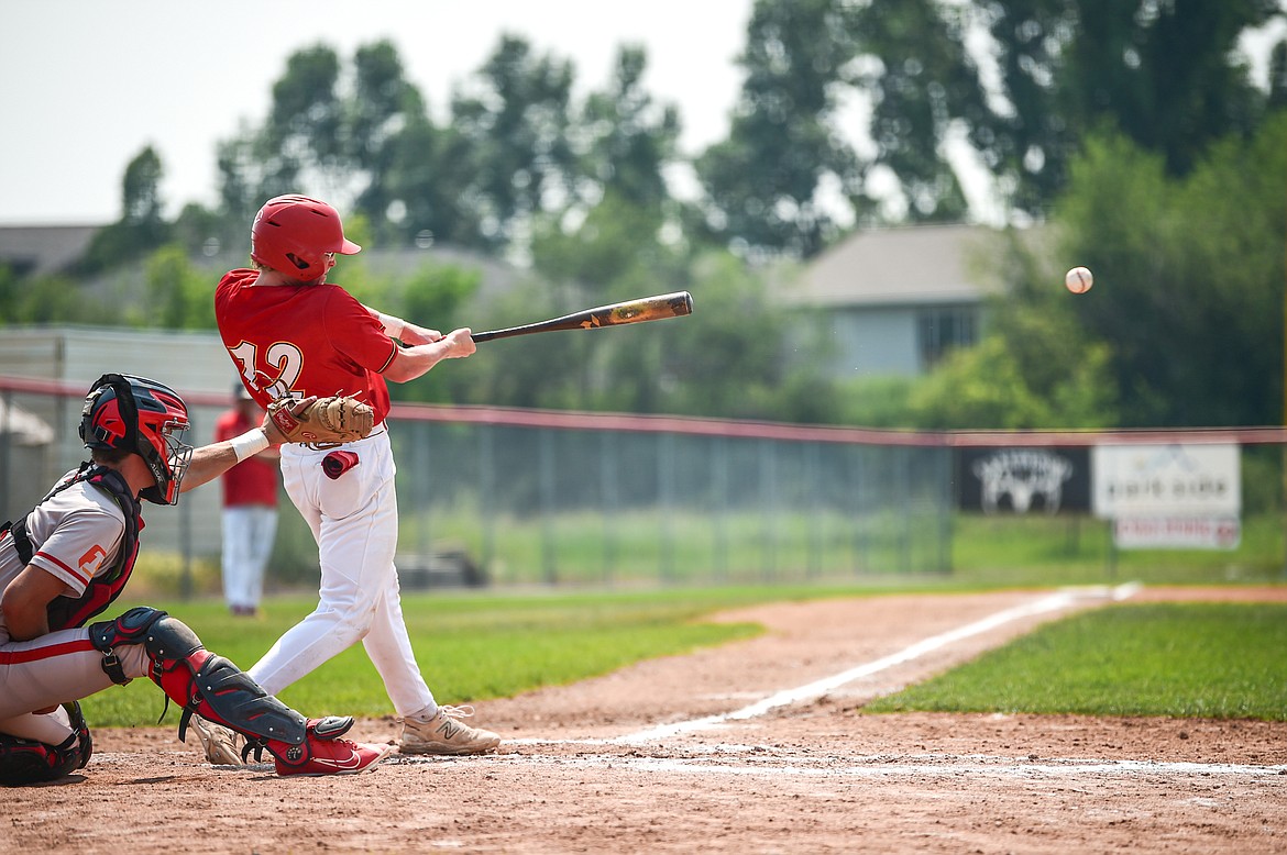 Kalispell's Luke Nikunen (12) connects on a single against the Billings Scarlets at Griffin Field on Thursday, July 18. (Casey Kreider/Daily Inter Lake)