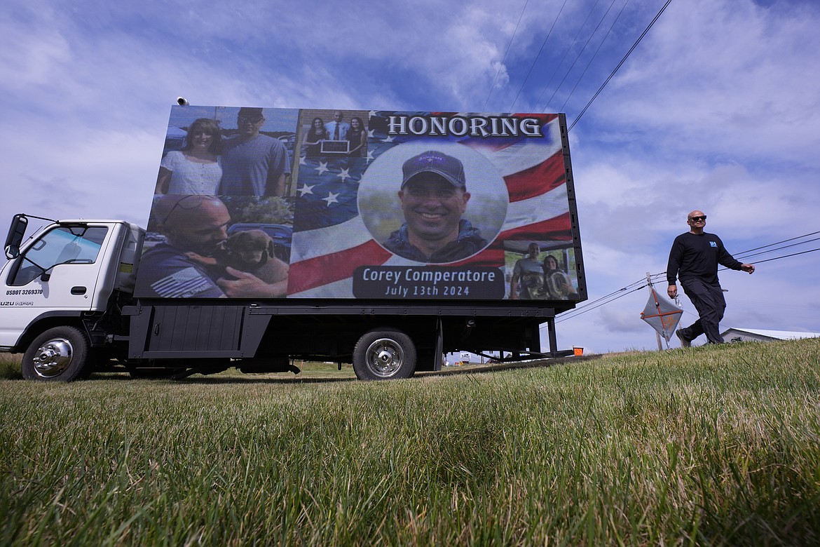 An electronic billboard displays a memorial for Corey Comperatore near the Butler Farm Show, Thursday, July 18, 2024, in Butler, Pa. Comperatore was killed at rally for former President Donald Trump Saturday. (AP Photo/Eric Gay)