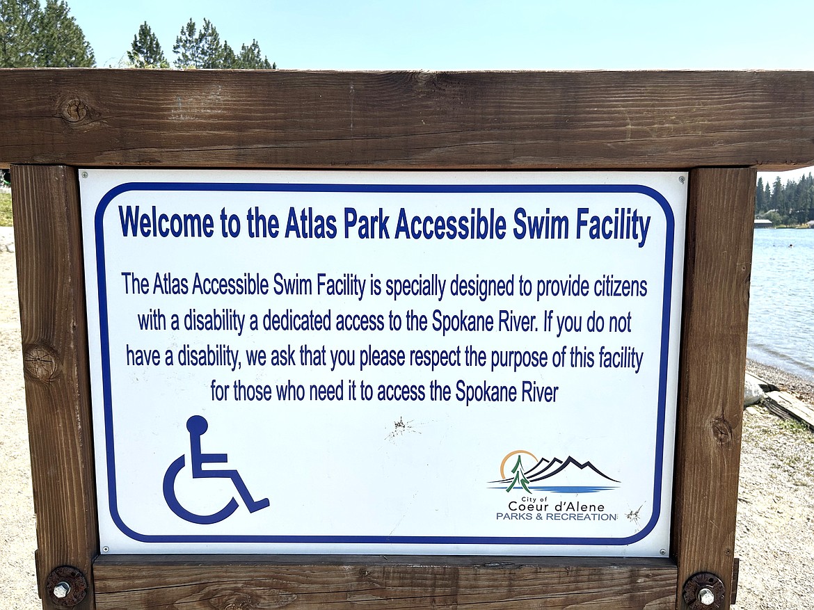 A sign outlines guidelines for using the ramp leading into the Spokane River for those with disabilities at Atlas Park.