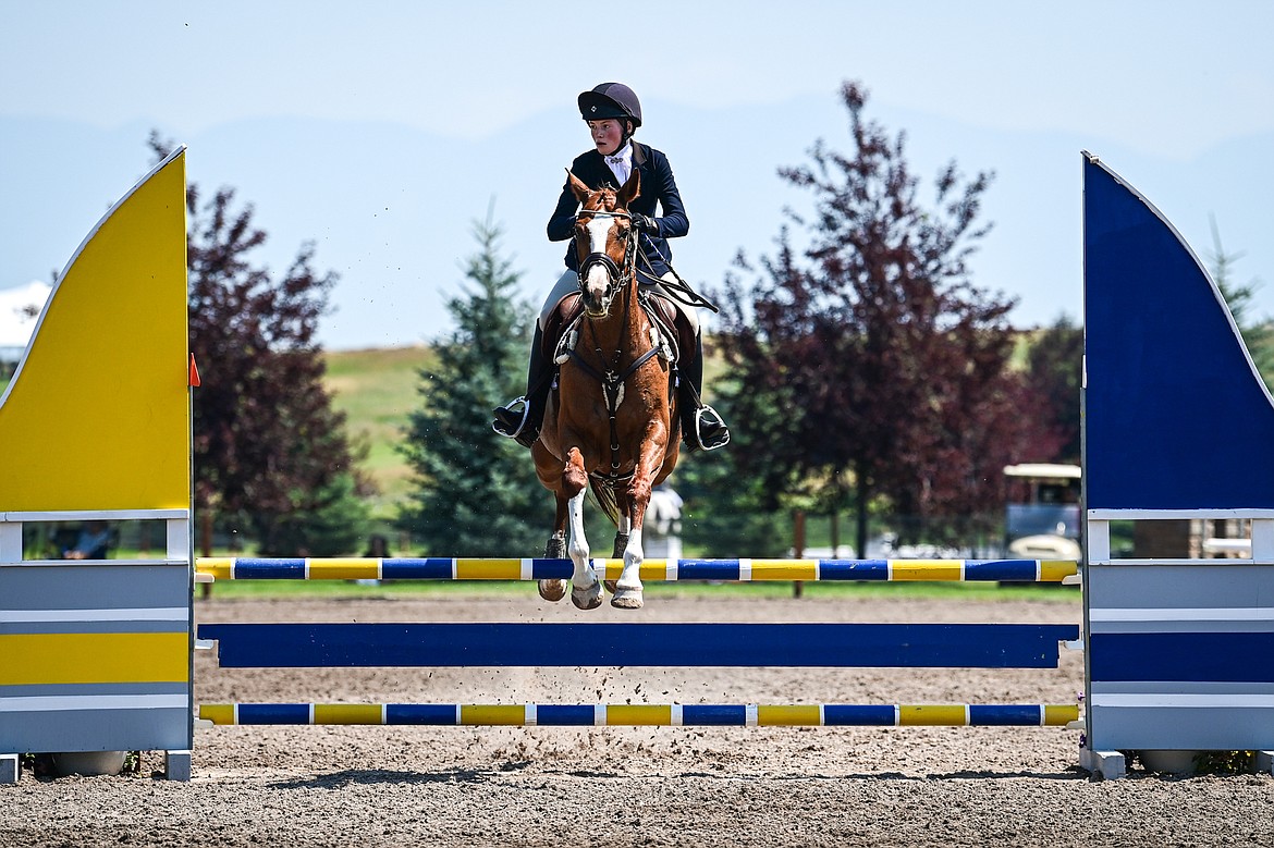 Freya McMullen rides Manzanita over a jump during Junior Open Novice A show jumping at The Event at Rebecca Farm on Friday, July 19. (Casey Kreider/Daily Inter Lake)