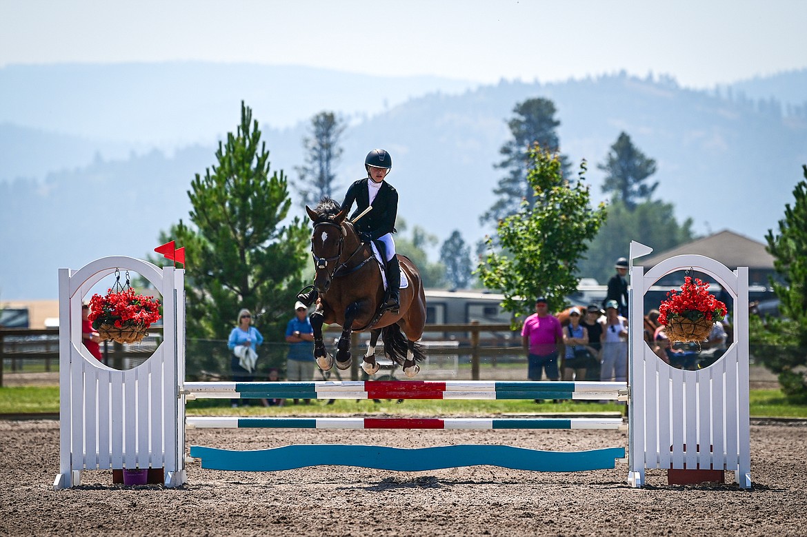 Lily Rhea rides Cooley Ever After over a jump during Junior Open Novice A show jumping at The Event at Rebecca Farm on Friday, July 19. (Casey Kreider/Daily Inter Lake)