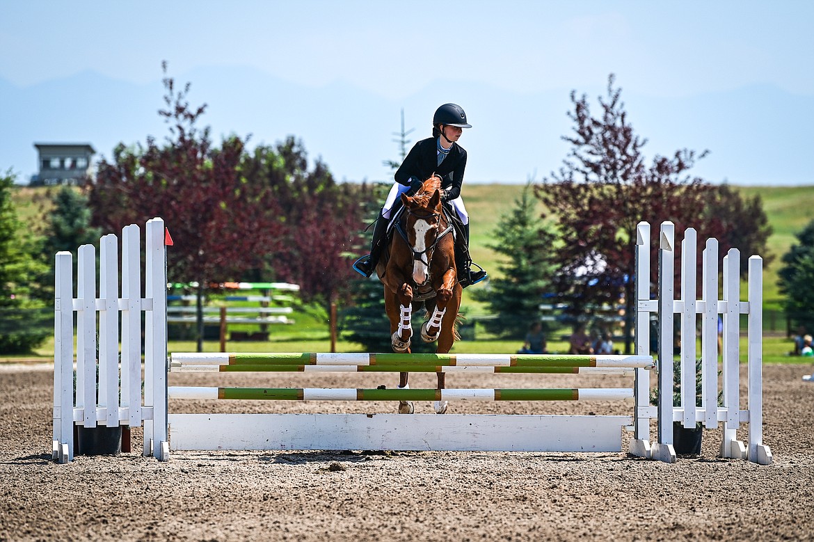 Emmalee Tanner rides Brazen Bugatti over a jump during Junior Open Novice A show jumping at The Event at Rebecca Farm on Friday, July 19. (Casey Kreider/Daily Inter Lake)