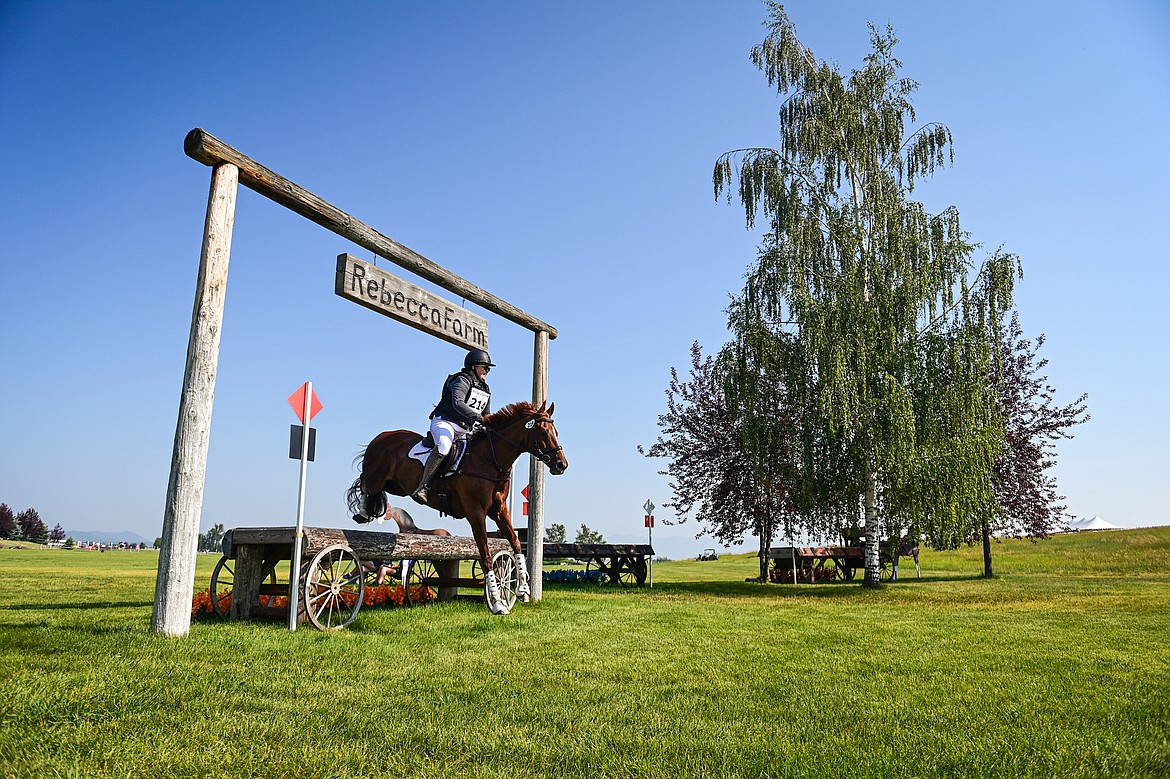 Renate Price rides She Owns The Room over a jump on the course during Training Three-Day cross-country at The Event at Rebecca Farm on Friday, July 19. (Casey Kreider/Daily Inter Lake)