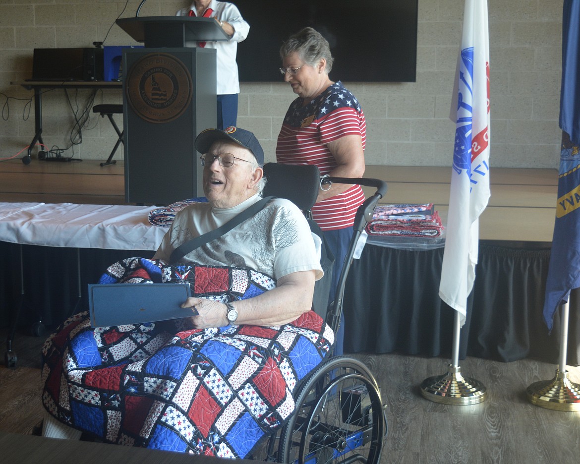 Eddie Siegel laughs as he receives his Quilt of Valor and certificate of honor from Giannine O'Connor Friday morning at Idaho State Veterans Home Post Falls.