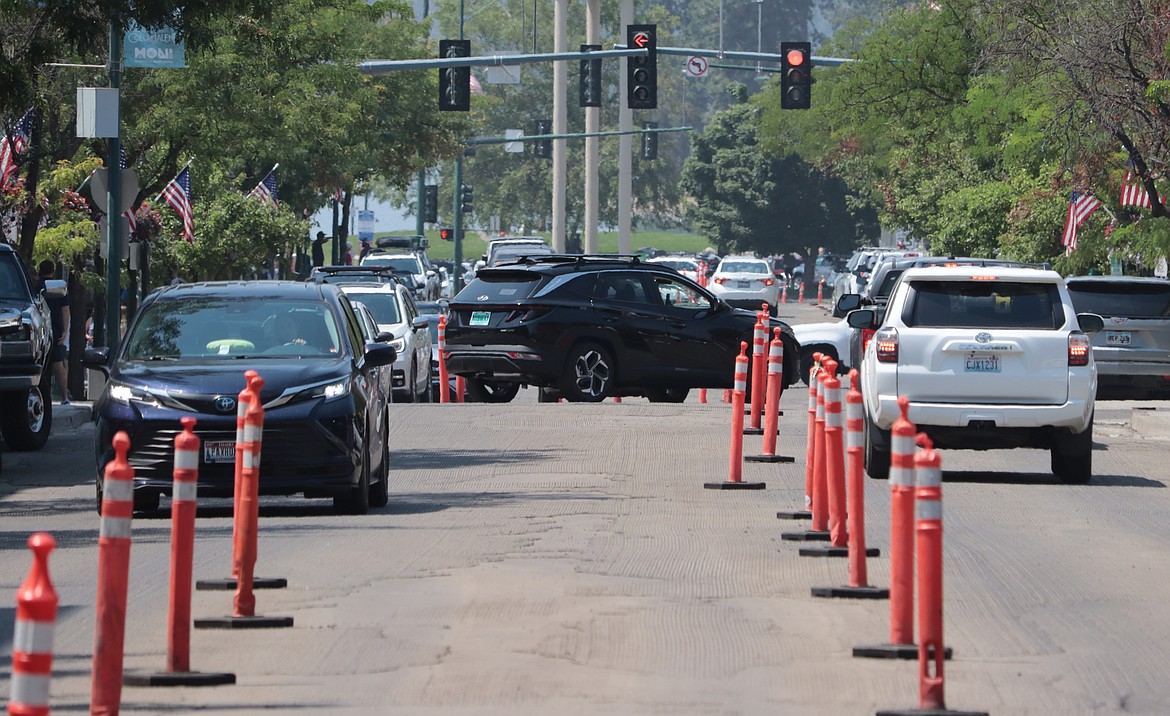 Drivers navigate their way past road markers on Sherman Avenue on Thursday.