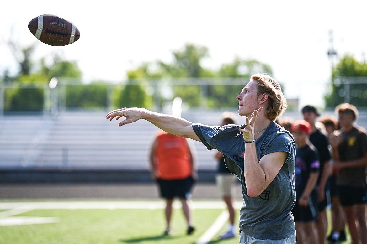 Flathead Braves quarterback Brett Pesola throws a pass during a drill at the Flathead Braves Football Camp hosted by NFL and Flathead High quarterback Brock Osweiler at Legends Stadium on Saturday, July 20. (Casey Kreider/Daily Inter Lake)