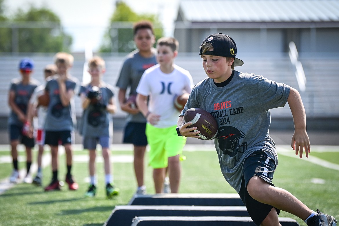 Campers run a drill at the Flathead Braves Football Camp hosted by former NFL and Flathead Braves quarterback Brock Osweiler at Legends Stadium on Saturday, July 20. (Casey Kreider/Daily Inter Lake)