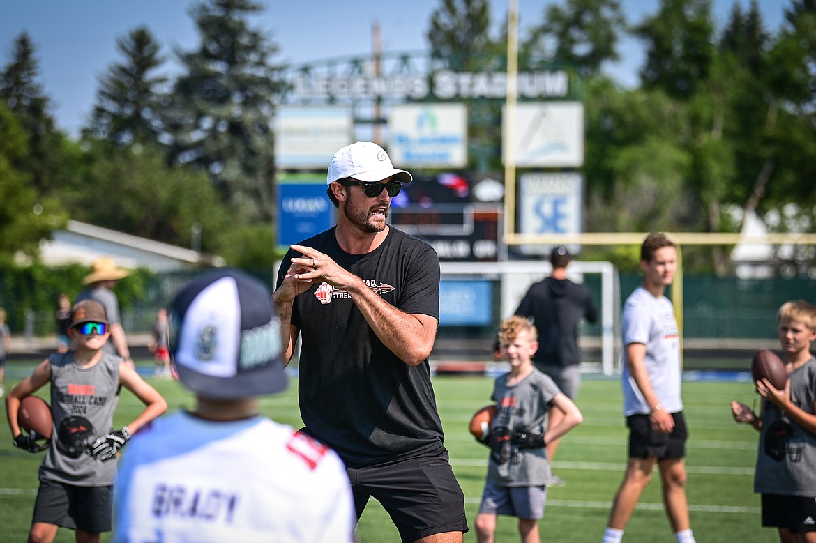 Former NFL and Flathead Braves quarterback Brock Osweiler demonstrates a three-step drop during a throwing drill with campers at the Flathead Braves Football Camp at Legends Stadium on Saturday, July 20. (Casey Kreider/Daily Inter Lake)