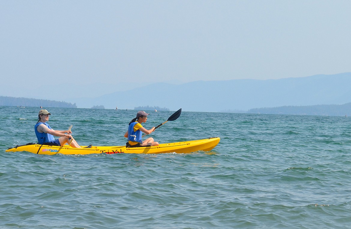 Two paddlers make for the finish line at Boettcher Park during Saturday's Poker Paddle, sponsored by the Flathead Lakers. (Kristi Niemeyer/Leader)