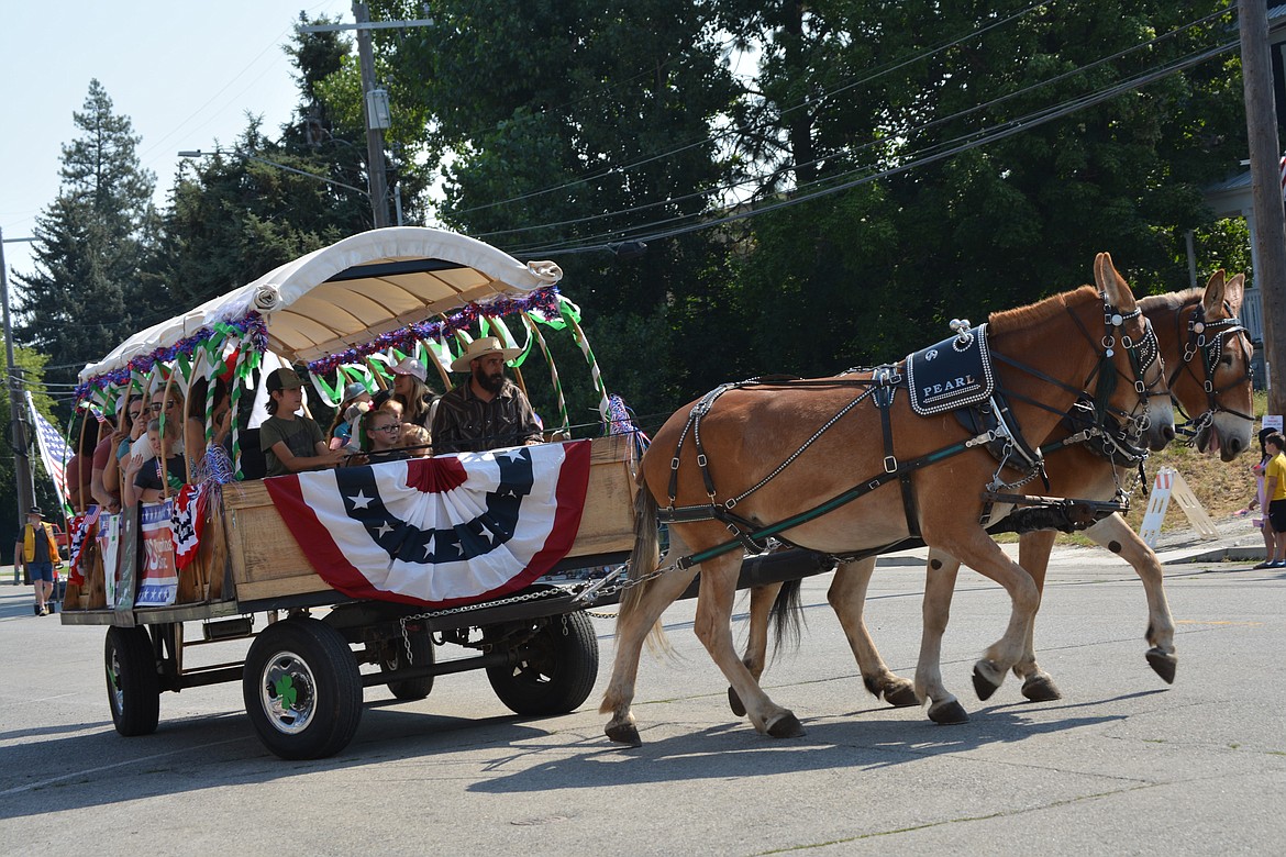 The 4-H club rides through the streets of Rathdrum in a wagon during a parade Saturday.