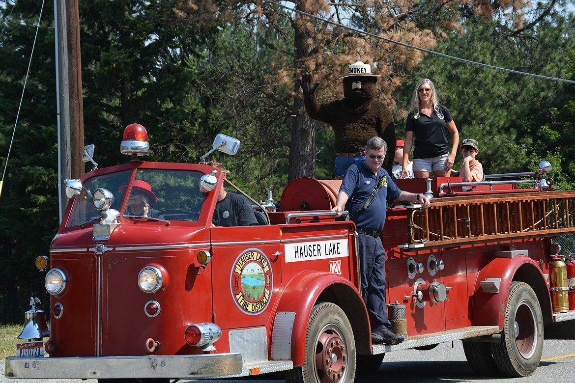 Smokey the Bear waves from a Hauser Lake Fire Department fire truck.