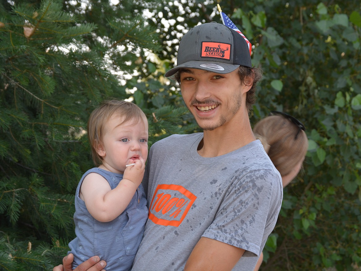 Dillon Burns holds little Kaisen Gardner Saturday morning during Gardner's first Rathdrum Days Parade.