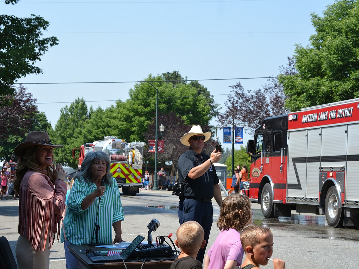 Sarah Polk, Kerri Thoreson and Chris Larson watch as the Northern Lakes Fire vehicles go past them Saturday during the Rathdrum Days parade.