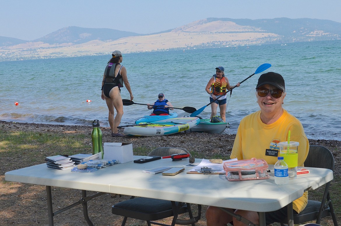 Flathead Lakers board member Marilyn Roberts prepares to check-in paddlers at the finish line of Saturday's Poker Paddle, which began and ended in Boettcher Park. (Kristi Niemeyer/Leader)