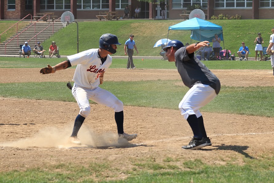 Photo by MICHAEL COOK
Jack Pierce celebrates with his dad, Coeur d'Alene Lums 17U coach Gil Pierce, as he rounds third base after hitting a grand slam against Northern Lakes in the championship game of the Class A Area A (district) tournament Sunday at Bear Field in Moscow.