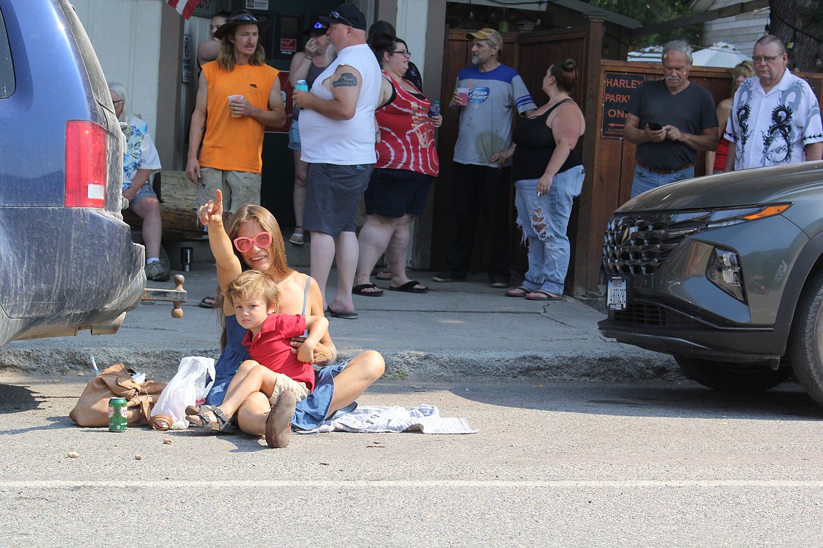 Trying to find shade had this mother and son ready to ambush the next parade entrant tossing candy. (Monte Turner/Mineral Independent)