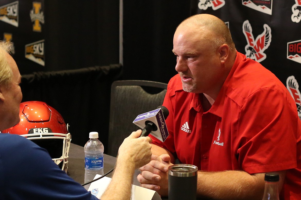 Eastern Washington Head Coach Aaron Best, right, speaks with a reporter at Monday’s Big Sky Media Days at the Northern Quest Casino in Spokane. Best highlighted the Eagle offensive line, which features four returning starters.