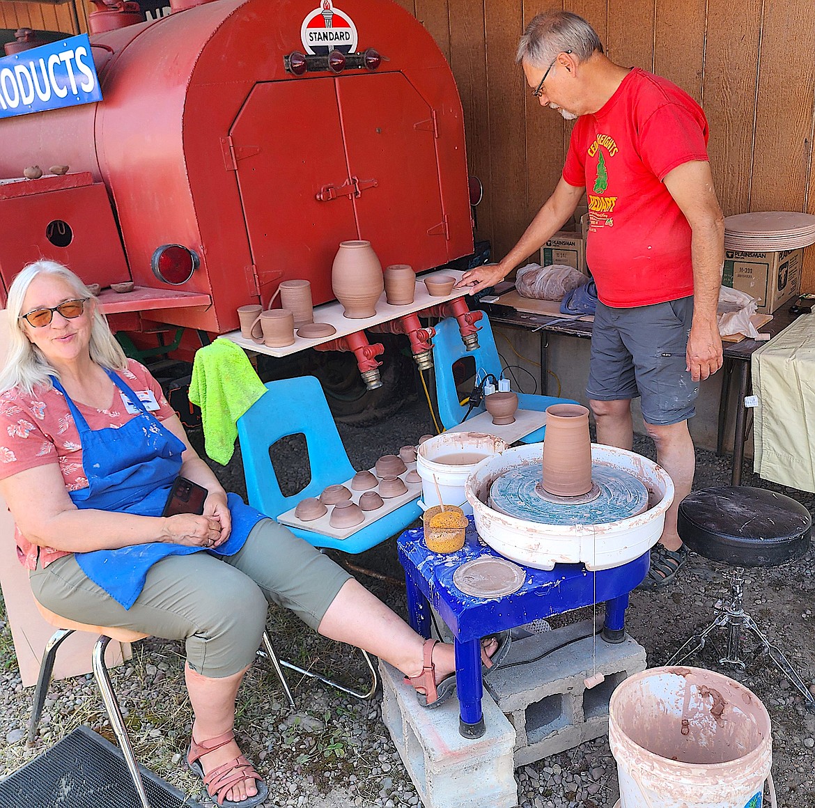 Potters Sheila and Jed Williams showed visitors how to throw pots on a wheel and make tiny slab pottery pots. (Berl Tiskus/Leader)