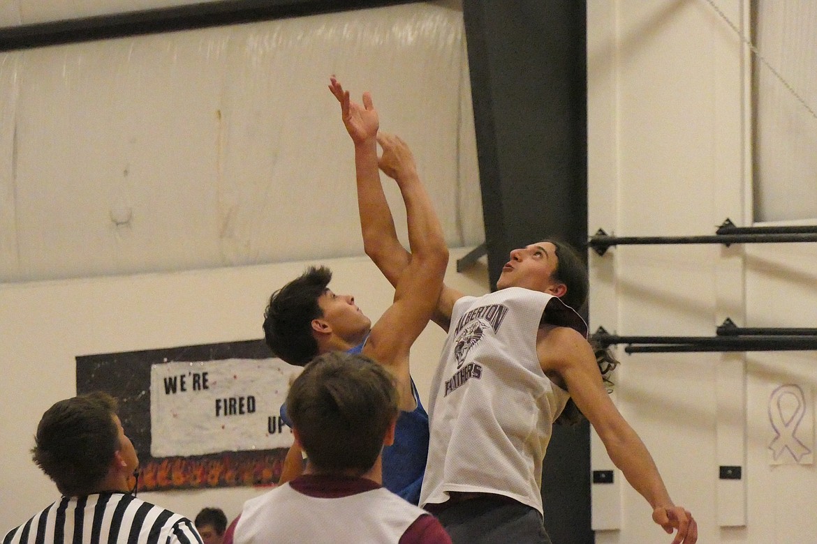 Alberton junior Shea Fredette (white jersey) and Nick McAllister battle for the opening tip of their summer game in Hot Springs last week. (Chuck Bandel/VP-MI)