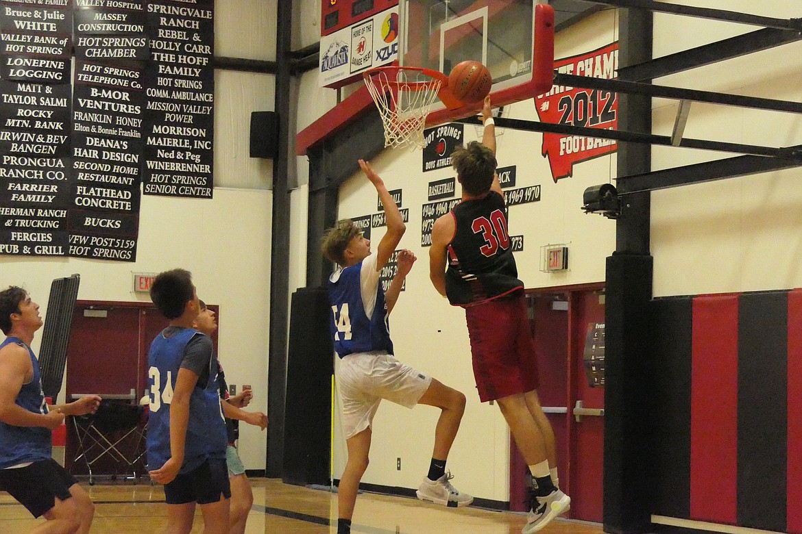 Hot Springs center Nick McAllister goes up for two against a T Falls defender during their summer game last week in Hot Springs.  (Chuck Bandel/VP-MI)